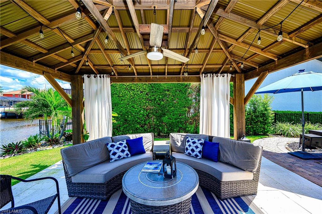 343 Conners Avenue Naples, FL 34108 - Photo 30 of 34 a outdoor living space with furniture and garden view
