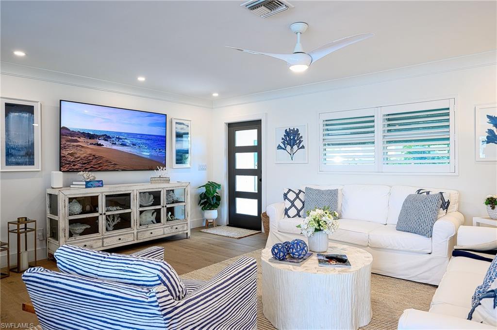 343 Conners Avenue Naples, FL 34108 - Photo 3 of 34 a living room with furniture and a flat screen tv