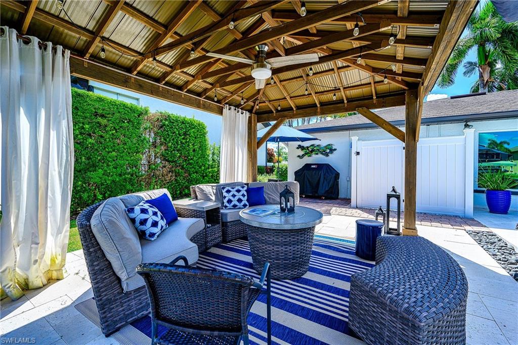 343 Conners Avenue Naples, FL 34108 - Photo 31 of 34 a view of a patio filled with furniture