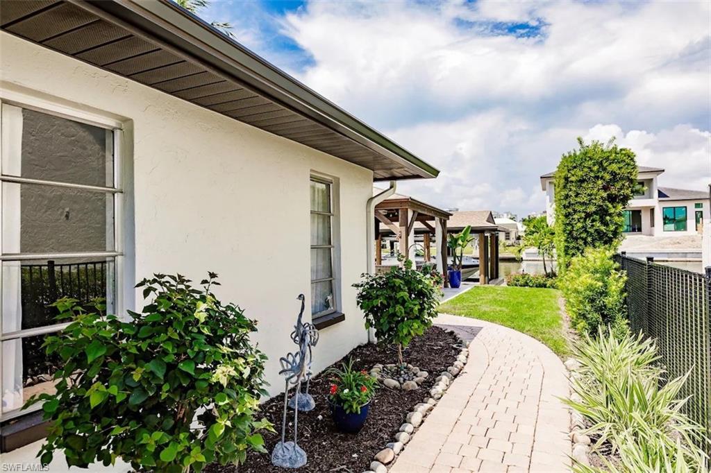 343 Conners Avenue Naples, FL 34108 - Photo 34 of 34 a front view of a house with garden