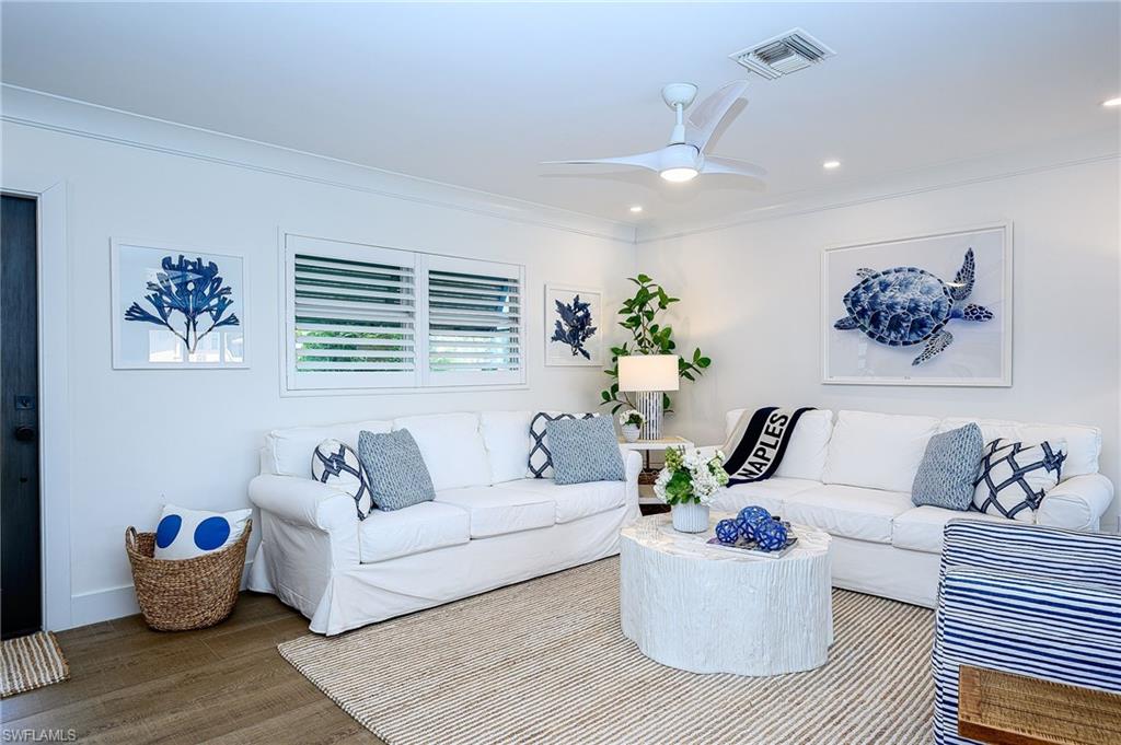 343 Conners Avenue Naples, FL 34108 - Photo 4 of 34 a living room with furniture and wooden floor