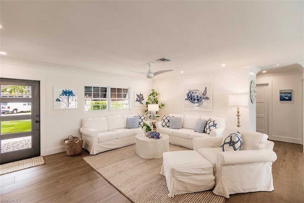 343 Conners Avenue Naples, FL 34108 - Photo 5 of 34 a living room with furniture and wooden floor