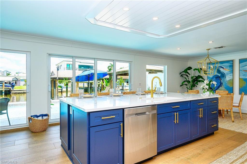 343 Conners Avenue Naples, FL 34108 - Photo 10 of 34 a kitchen with sink and view of living room
