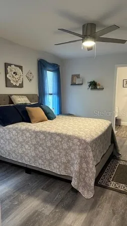 a bedroom with a bed and painting on the wall