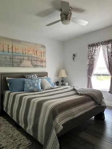 a bedroom with a bed and window