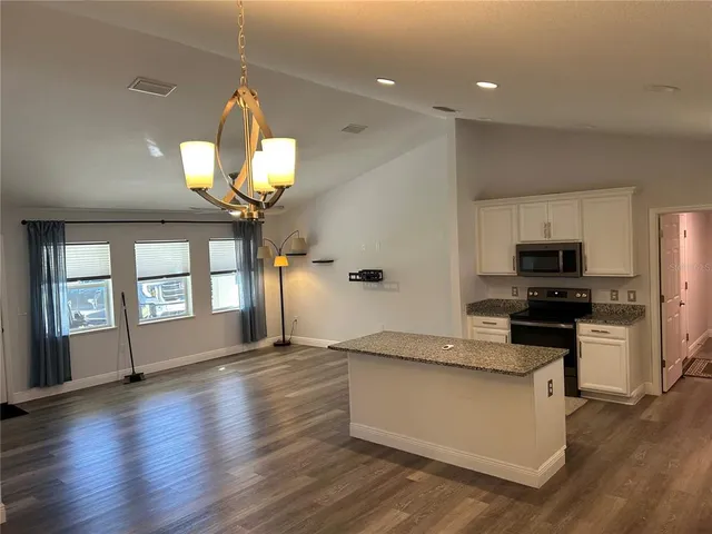 a view of a kitchen with a sink stainless steel appliances and cabinets