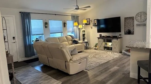 a living room with furniture and a flat screen tv