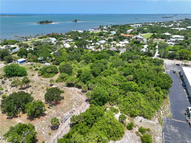 an aerial view of a houses with a yard