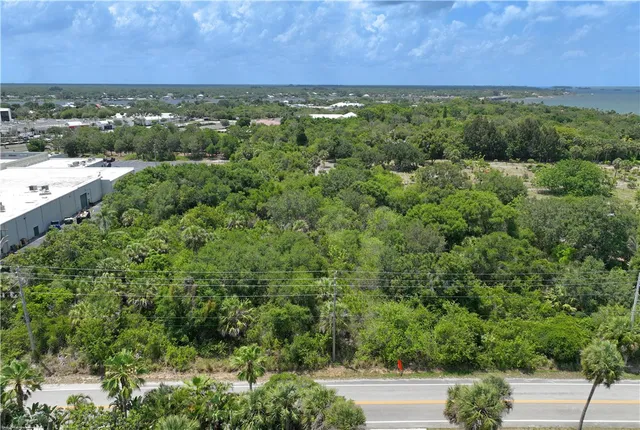 a view of a green field with lots of bushes