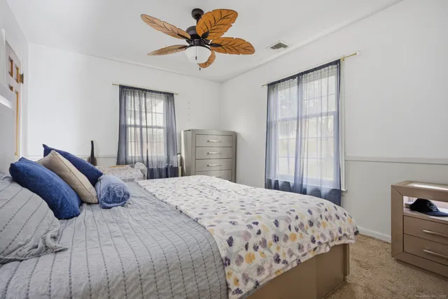 a bedroom with a bed and dresser