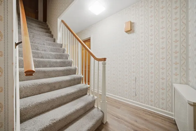 a view of staircase with white walls and a window