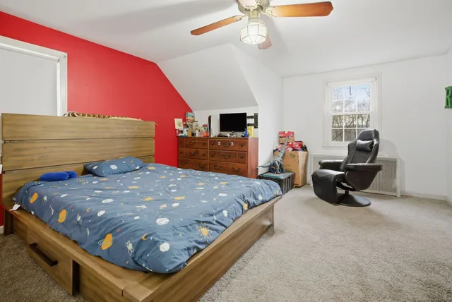 a bed sitting in a room next to a window