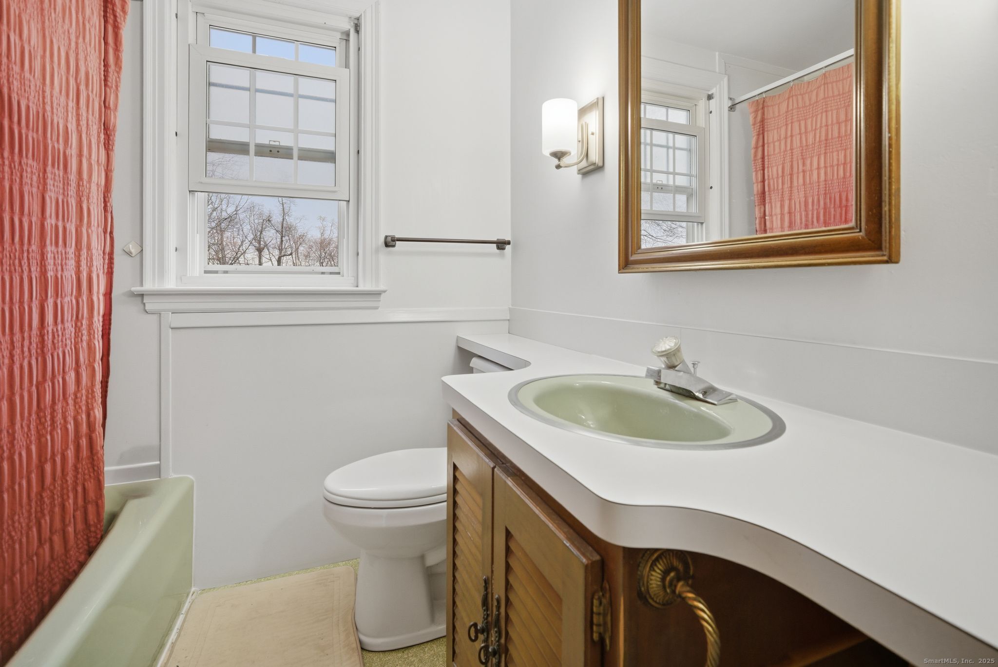 23 Baldwin Street Meriden, CT 06451 - Photo 26 of 40 a bathroom with a sink a toilet and a mirror