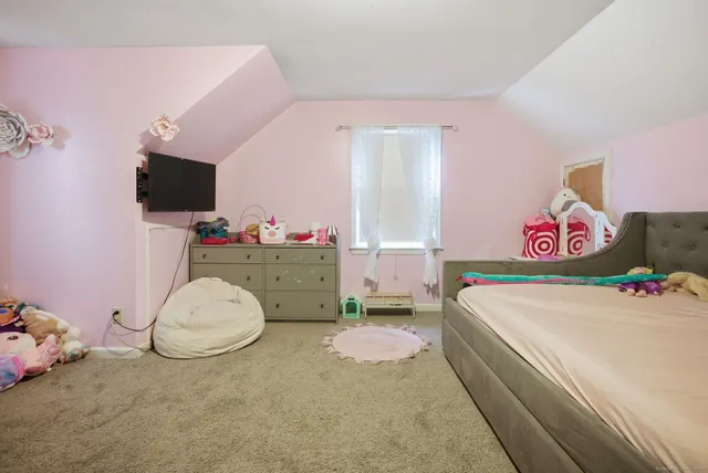 a bedroom with a bed and flat screen tv