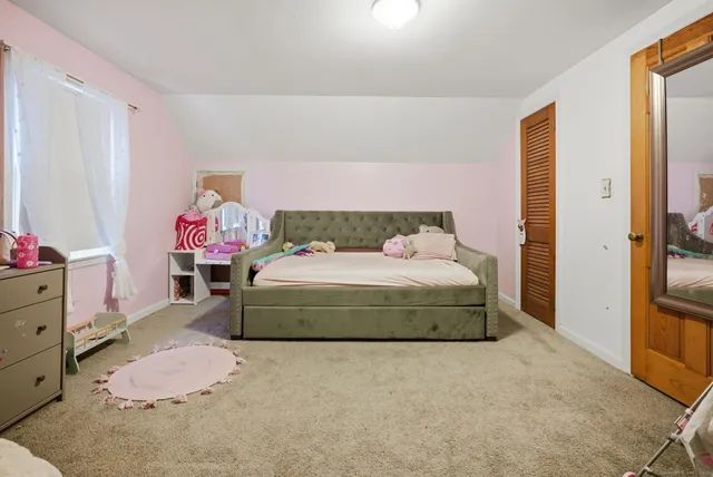 a bedroom with a bed and a dresser