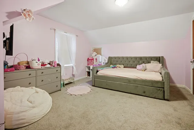 a bedroom with a bed and a dresser