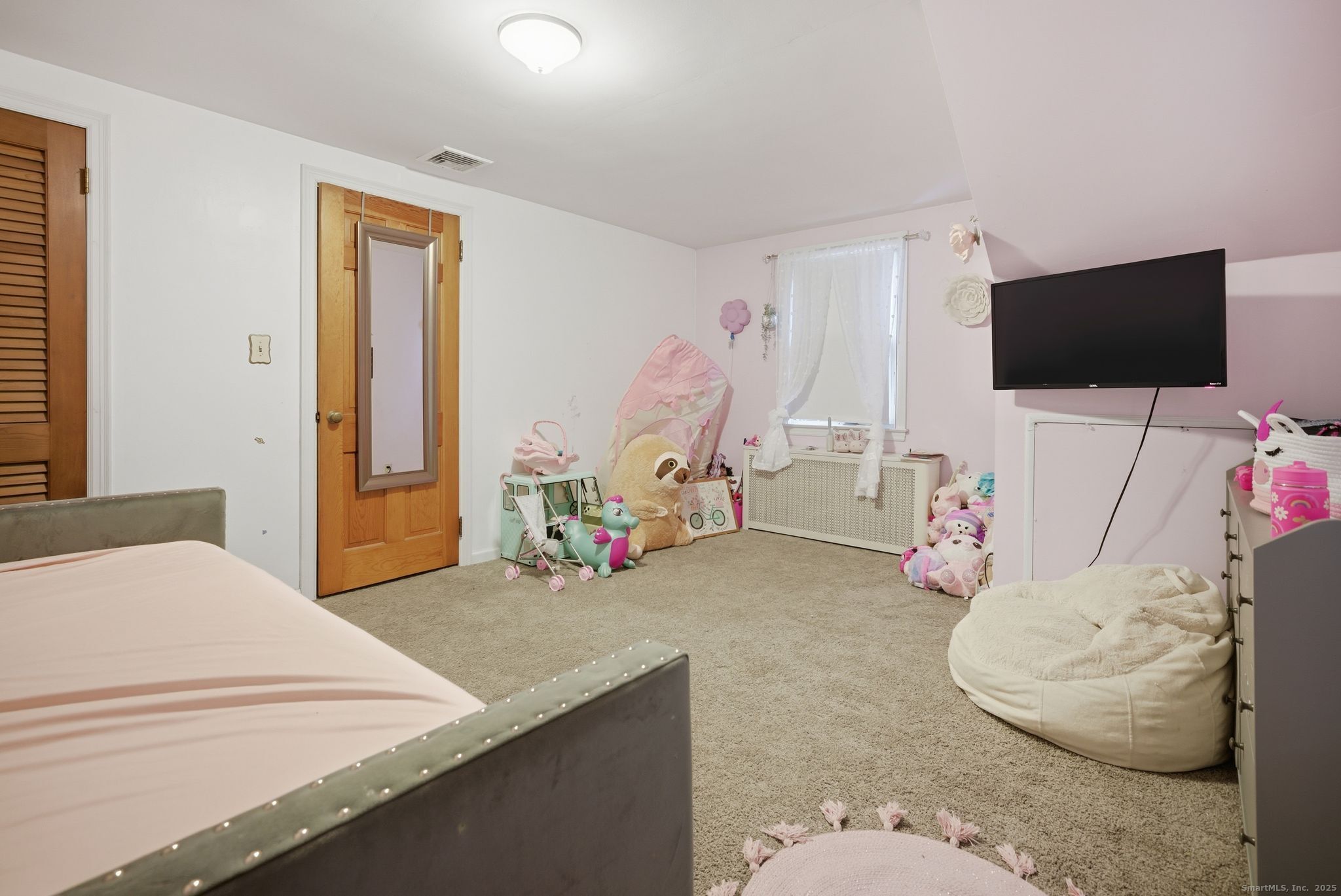 23 Baldwin Street Meriden, CT 06451 - Photo 30 of 40 a bedroom with a bed and a flat screen tv