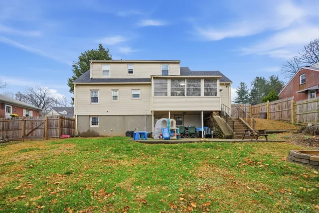 a view of a house with a big yard and large trees