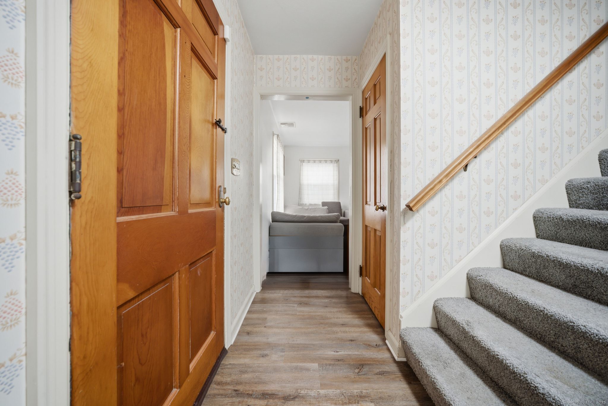 23 Baldwin Street Meriden, CT 06451 - Photo 4 of 40 a view of a hallway with wooden floor and staircase