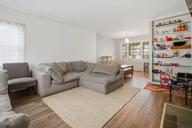 a living room with furniture a baby crib and a couch