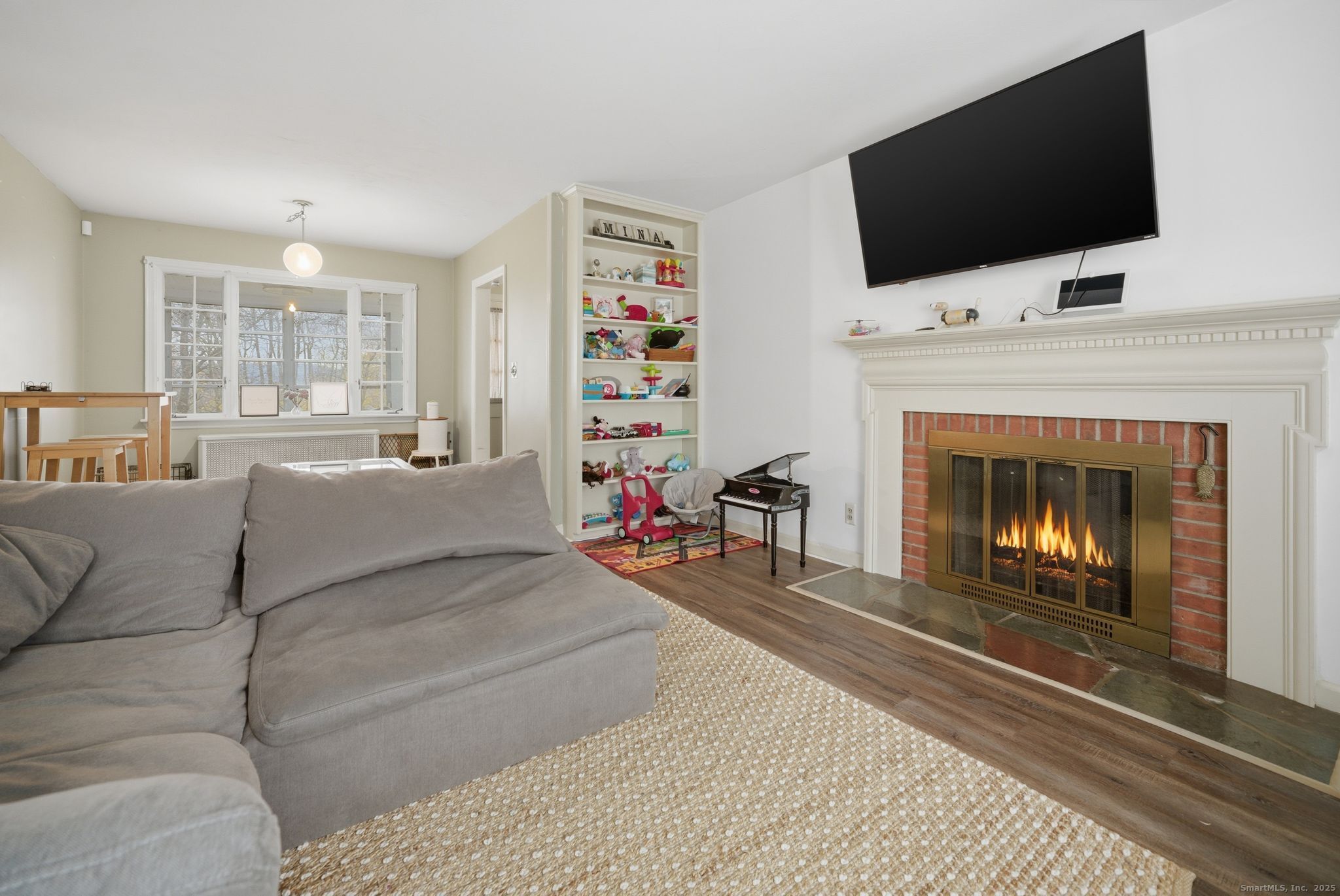 23 Baldwin Street Meriden, CT 06451 - Photo 6 of 40 a living room with a flat screen tv and a fireplace