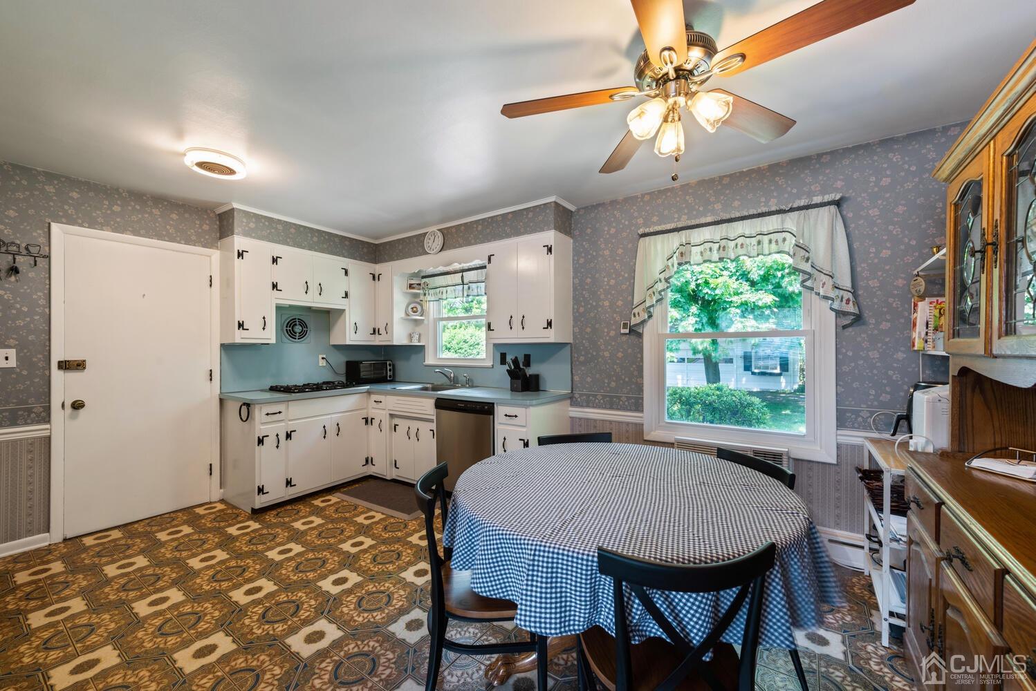 76 Orchard Road Middlesex, NJ 08846 - Photo 12 of 31 a kitchen with stainless steel appliances granite countertop a stove a refrigerator a kitchen island a couches table and chairs with wooden floor