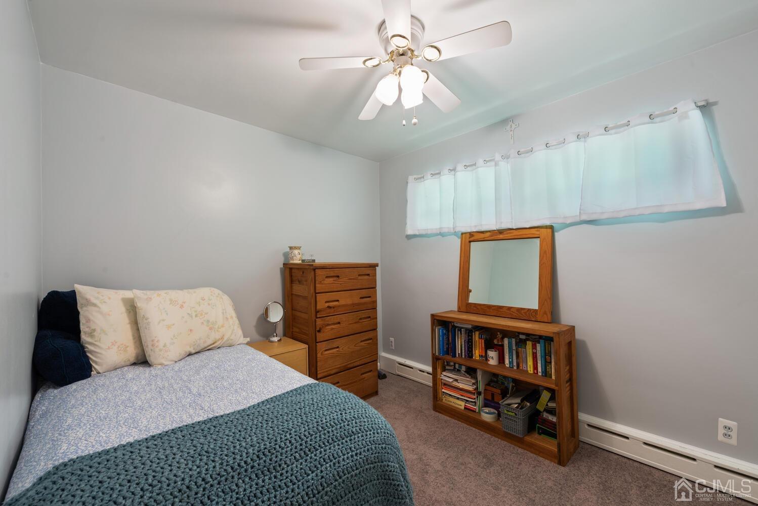 76 Orchard Road Middlesex, NJ 08846 - Photo 17 of 31 a bedroom with a bed a dresser and a chandelier