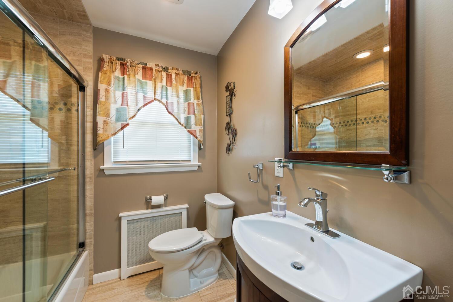76 Orchard Road Middlesex, NJ 08846 - Photo 19 of 31 a bathroom with a sink toilet and a mirror