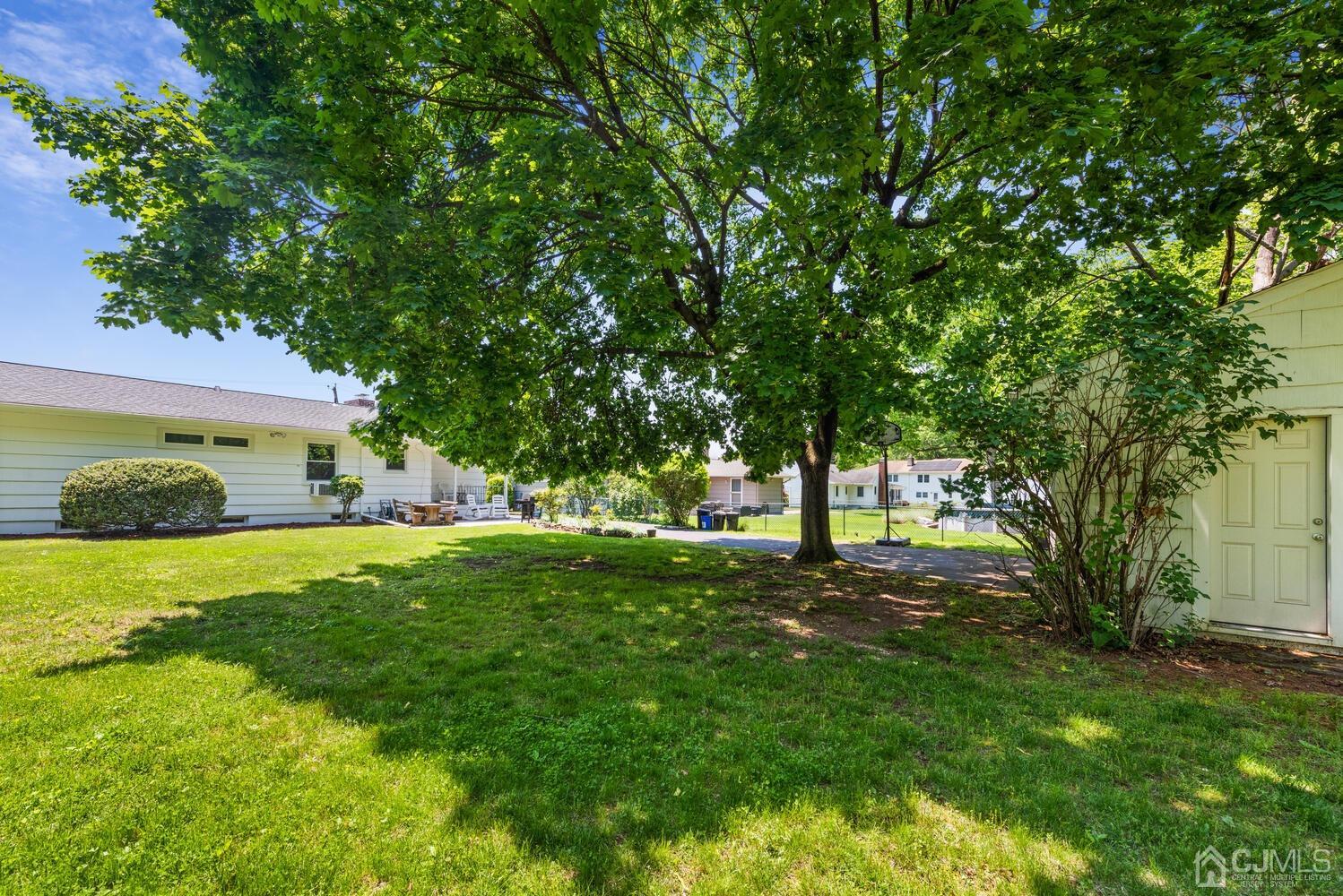 76 Orchard Road Middlesex, NJ 08846 - Photo 29 of 31 a view of a big yard with plants and large trees