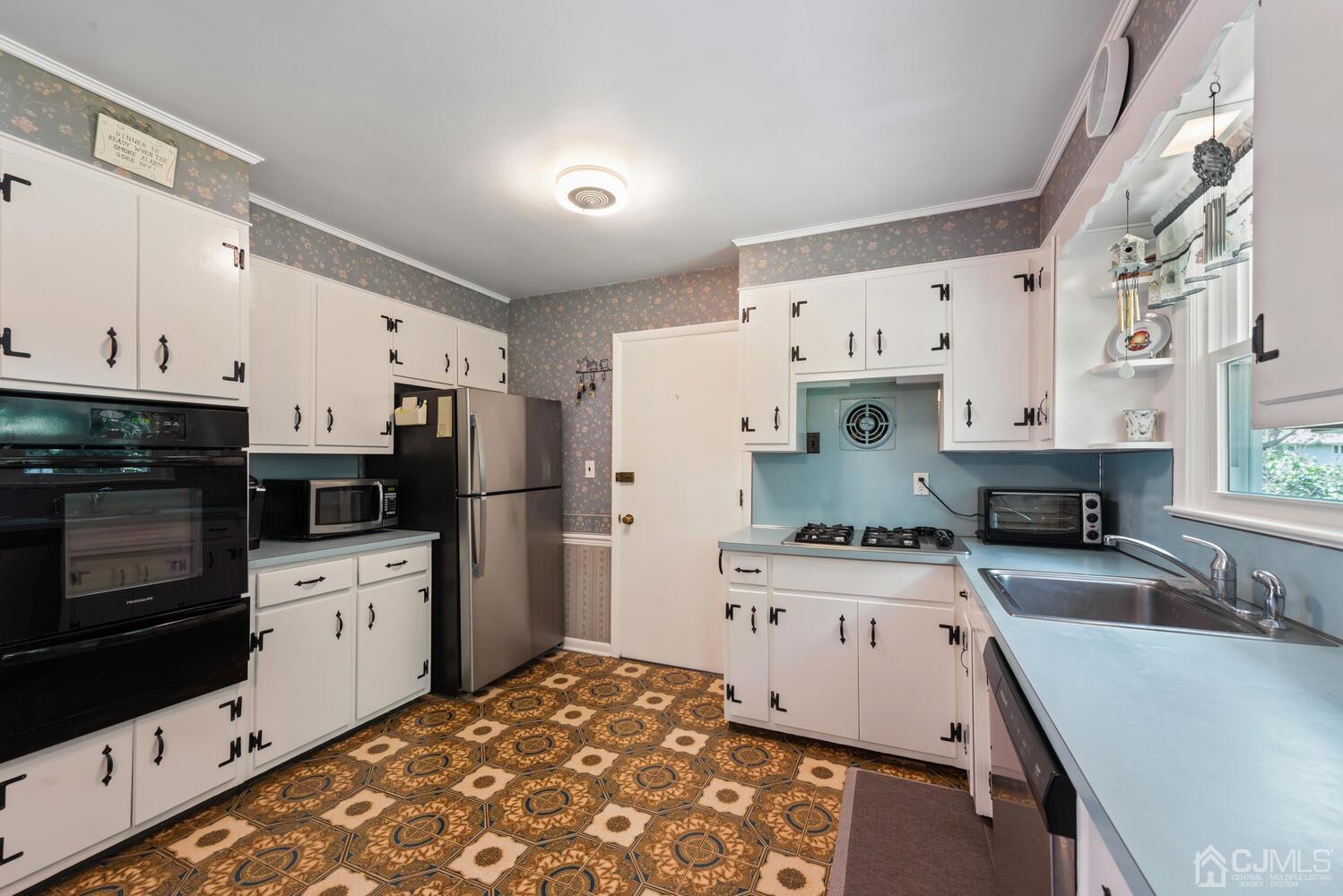 76 Orchard Road Middlesex, NJ 08846 - Photo 10 of 31 a kitchen with stainless steel appliances a stove a sink and a refrigerator