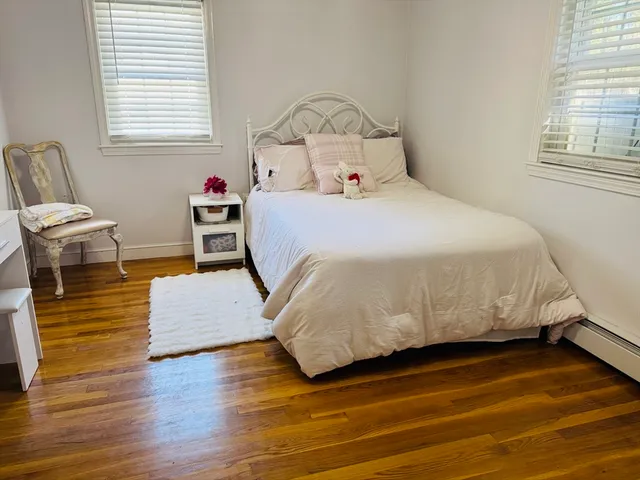a bed room with furniture and wooden floor