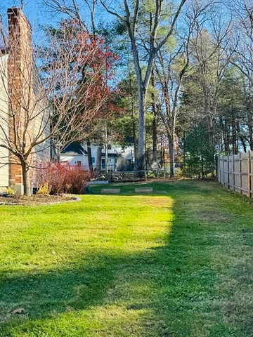 a swimming pool with outdoor seating and yard
