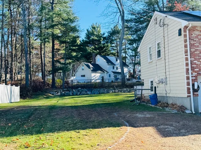a swimming pool with outdoor seating and yard