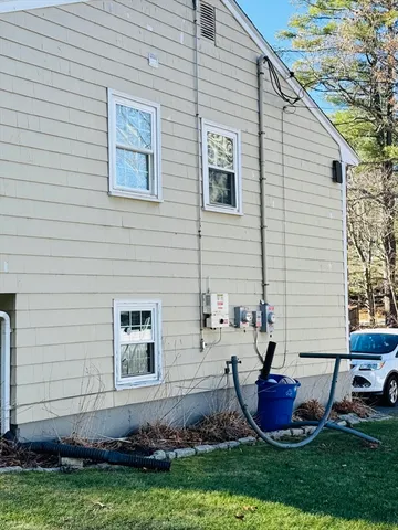 a view of house with backyard space and garden