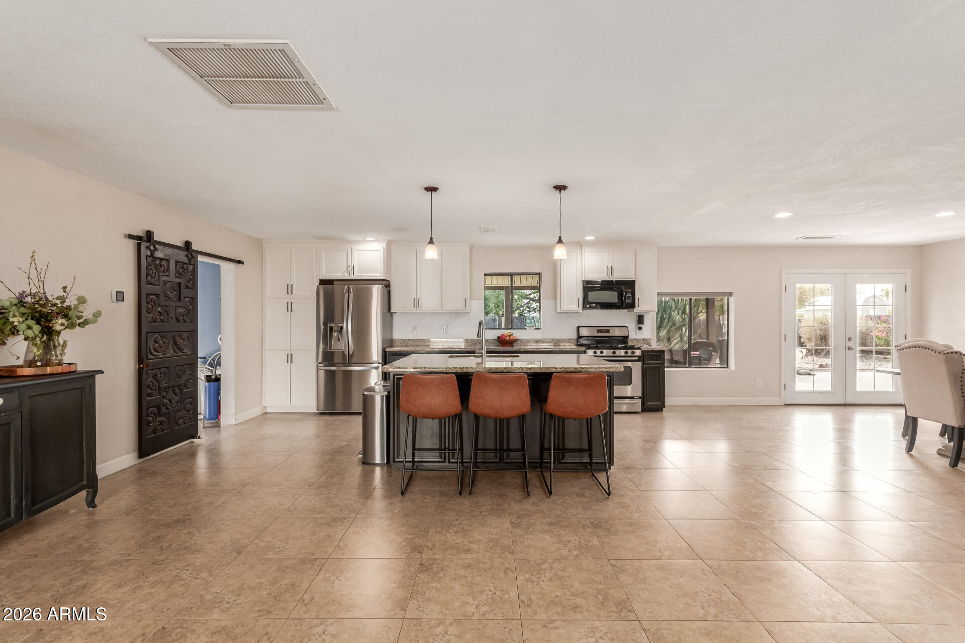 313 West Saddle Mountain Road Phoenix, AZ 85086 - Photo 16 of 54 a open kitchen with stainless steel appliances a dining table chairs and granite counter tops
