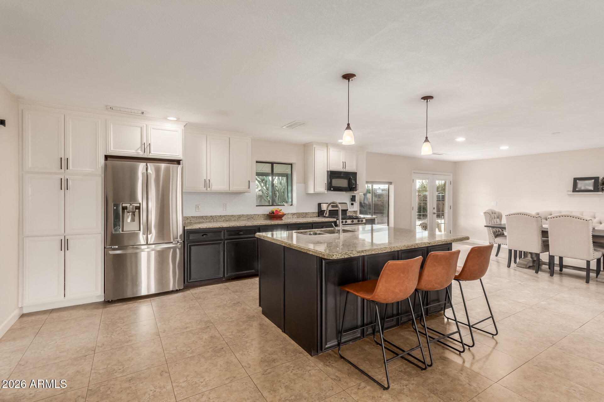 313 West Saddle Mountain Road Phoenix, AZ 85086 - Photo 18 of 54 a kitchen with stainless steel appliances granite countertop a sink a stove a refrigerator and island with wooden floor