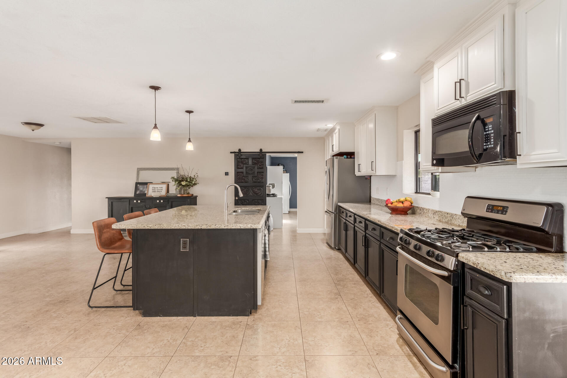 313 West Saddle Mountain Road Phoenix, AZ 85086 - Photo 19 of 54 a kitchen with stainless steel appliances a sink a stove top oven a counter top space cabinets and stainless steel appliances