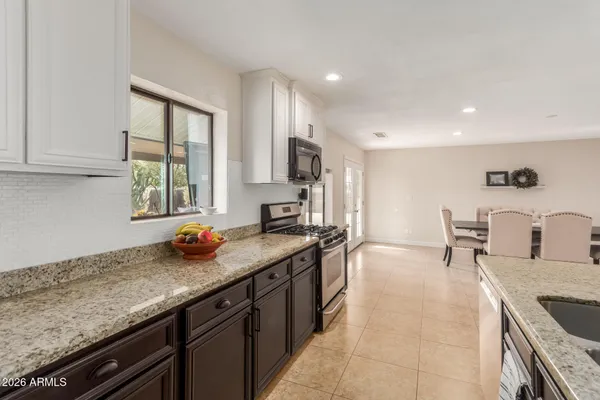a kitchen with a sink stove and cabinets