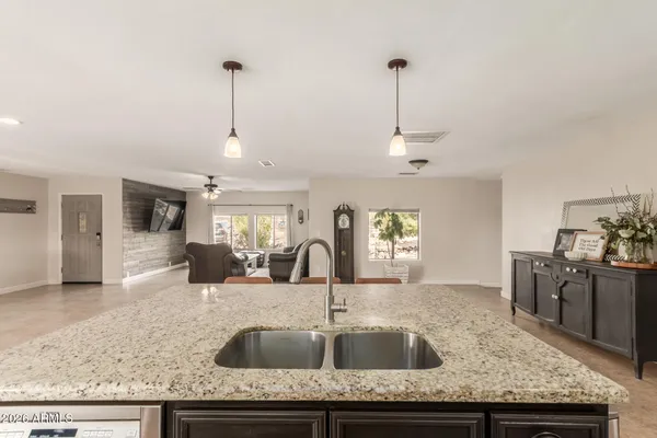 a kitchen with granite countertop a sink and center island