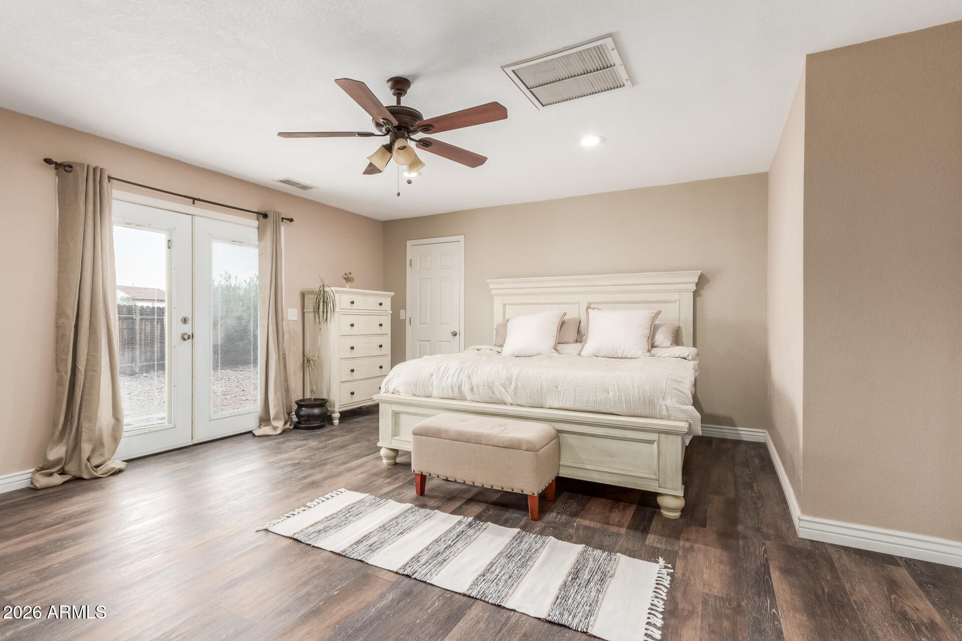 313 West Saddle Mountain Road Phoenix, AZ 85086 - Photo 22 of 54 a bedroom with a large bed and a chandelier