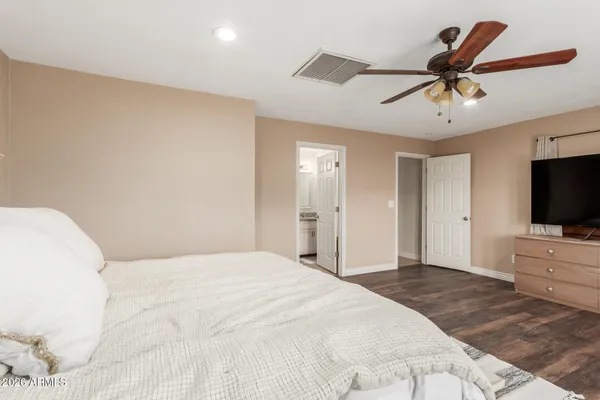 a bedroom with a bed and a flat screen tv