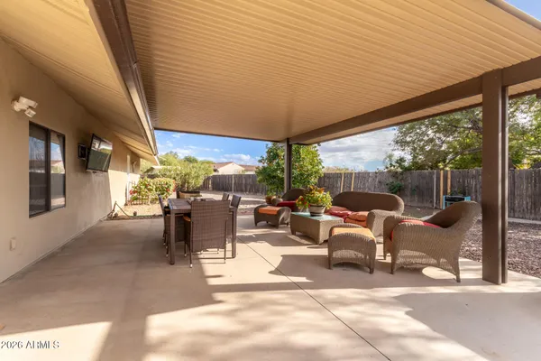 a view of a patio with a table and chairs and potted plants