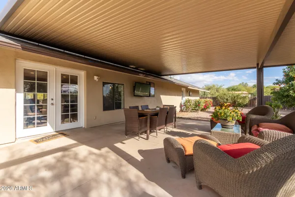 a view of a patio with couches chairs and potted plants