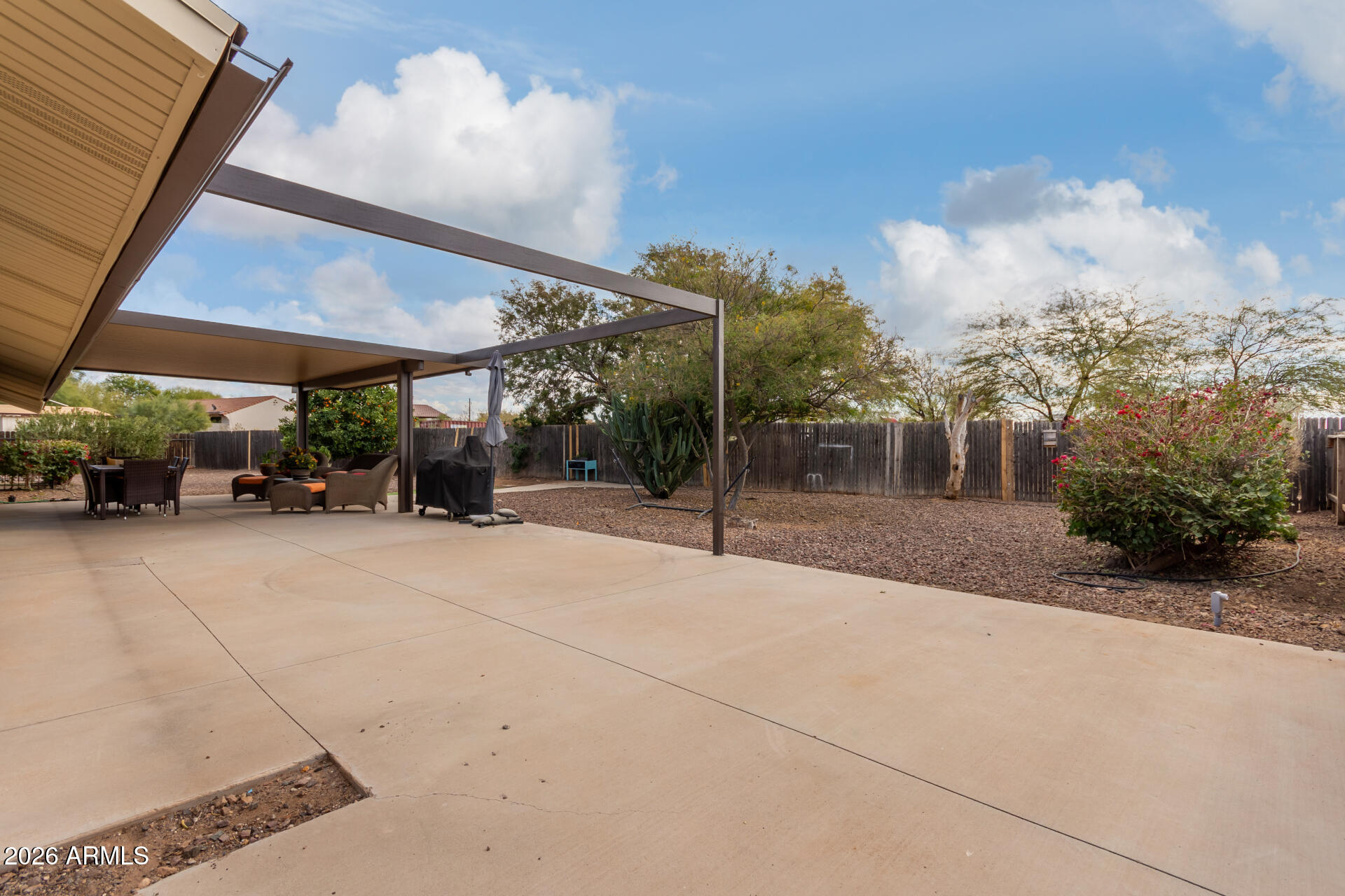 313 West Saddle Mountain Road Phoenix, AZ 85086 - Photo 45 of 54 a view of a patio with table and chairs under an umbrella
