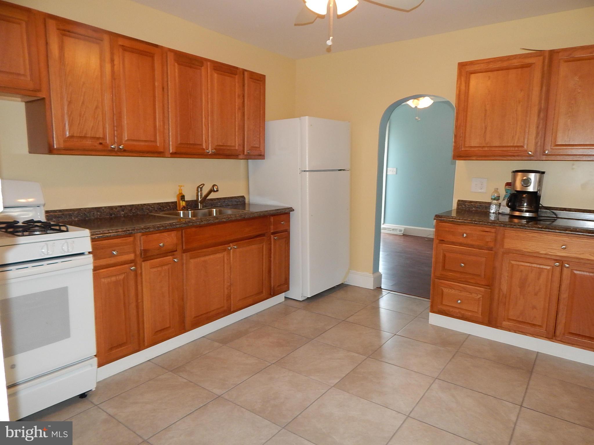12 Crafton Road Baltimore, MD 21221 - Photo 2 of 28 a kitchen with stainless steel appliances granite countertop a refrigerator stove top oven and sink