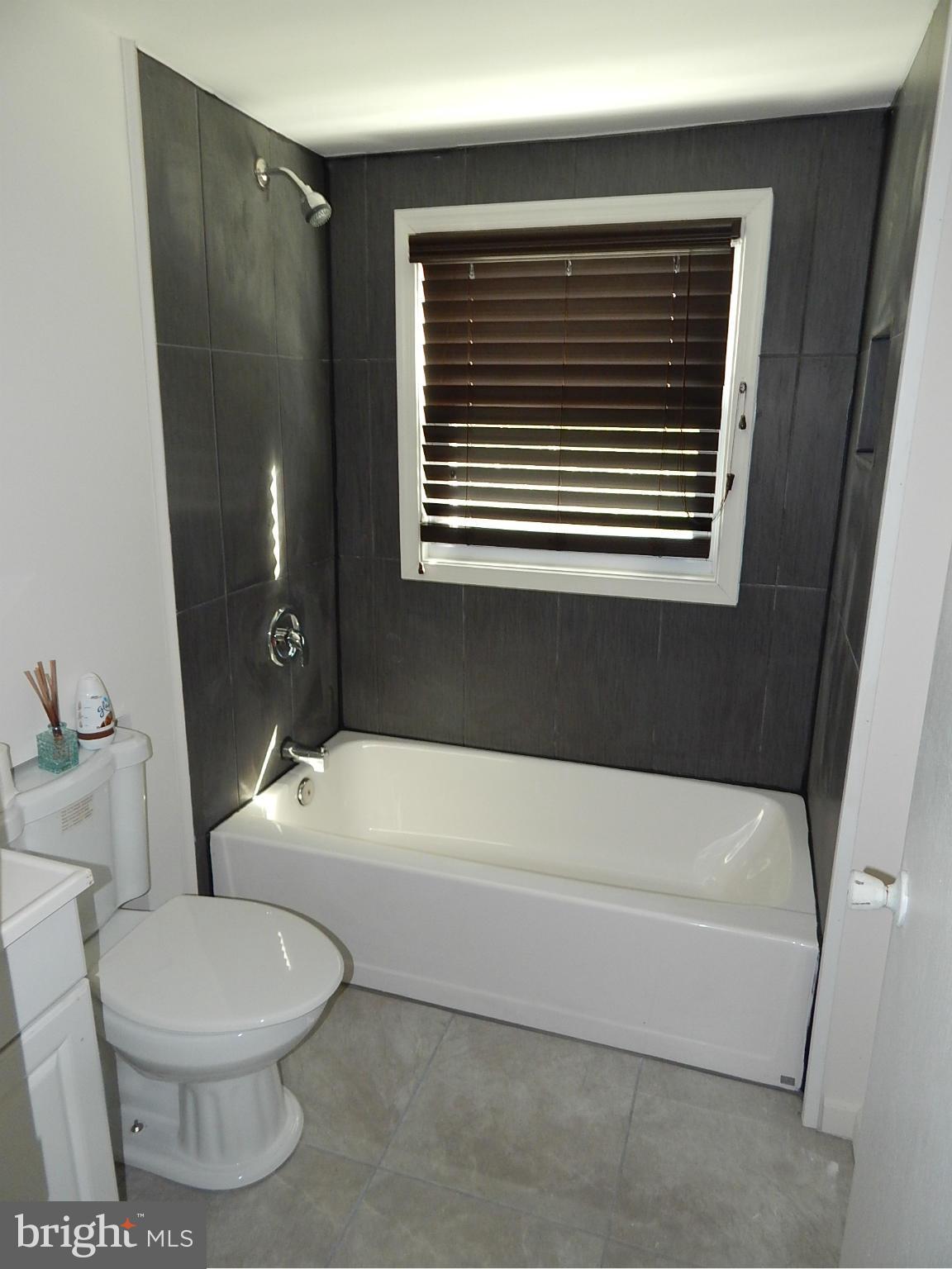 12 Crafton Road Baltimore, MD 21221 - Photo 18 of 28 a bathroom with a toilet a sink and bathtub