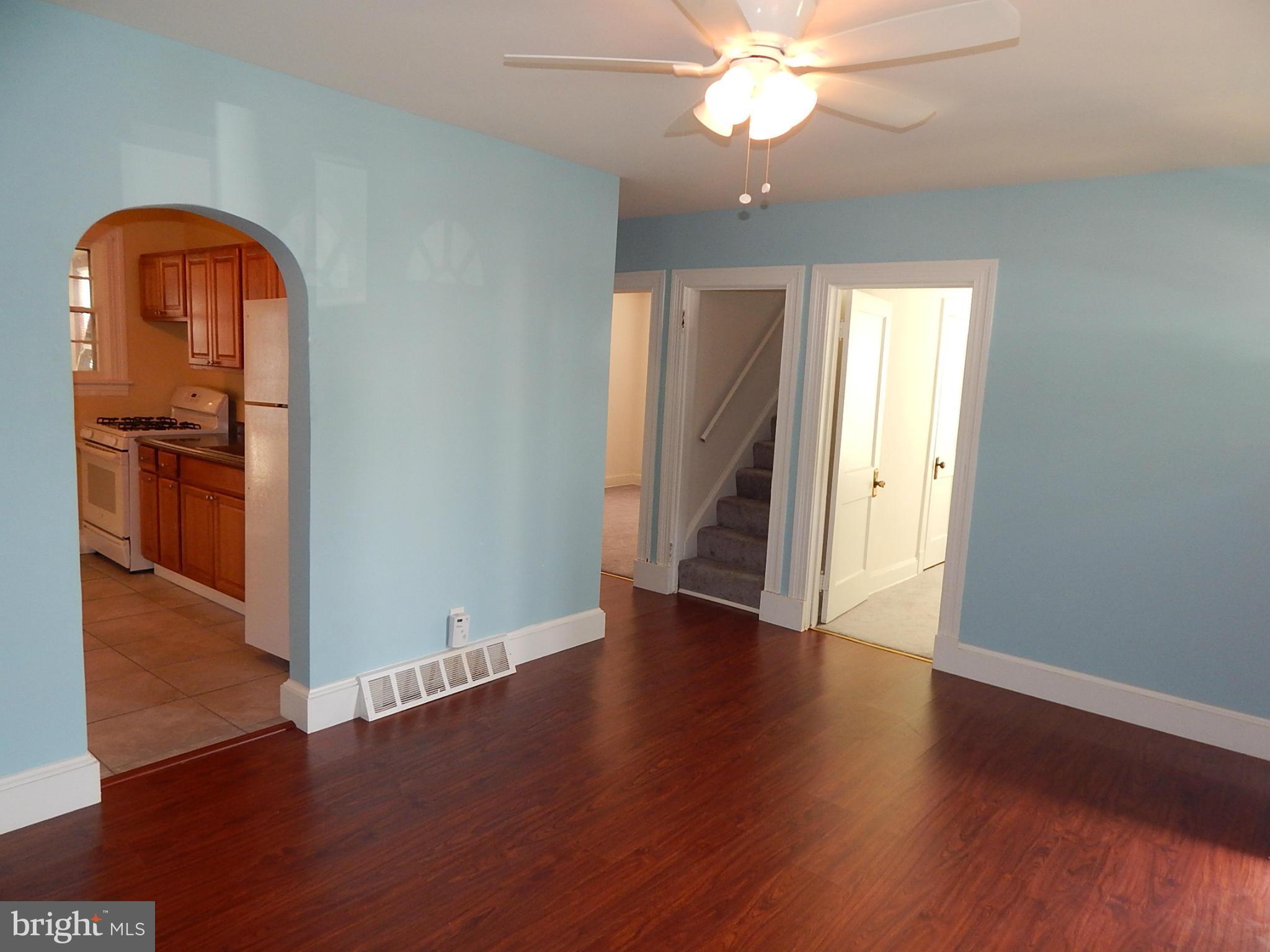 12 Crafton Road Baltimore, MD 21221 - Photo 3 of 28 wooden floor in an empty room with a window