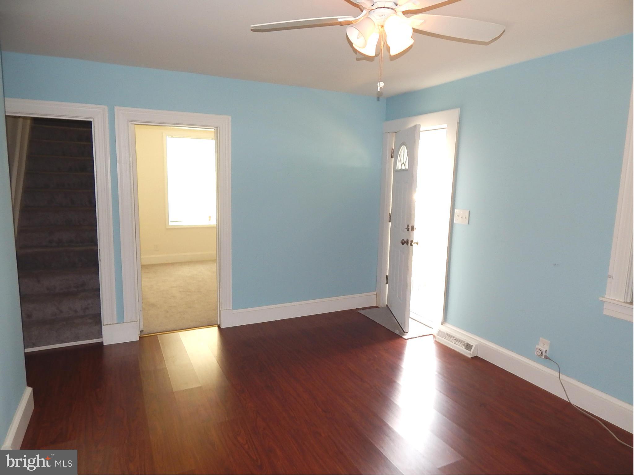 12 Crafton Road Baltimore, MD 21221 - Photo 5 of 28 an empty room with wooden floor and windows