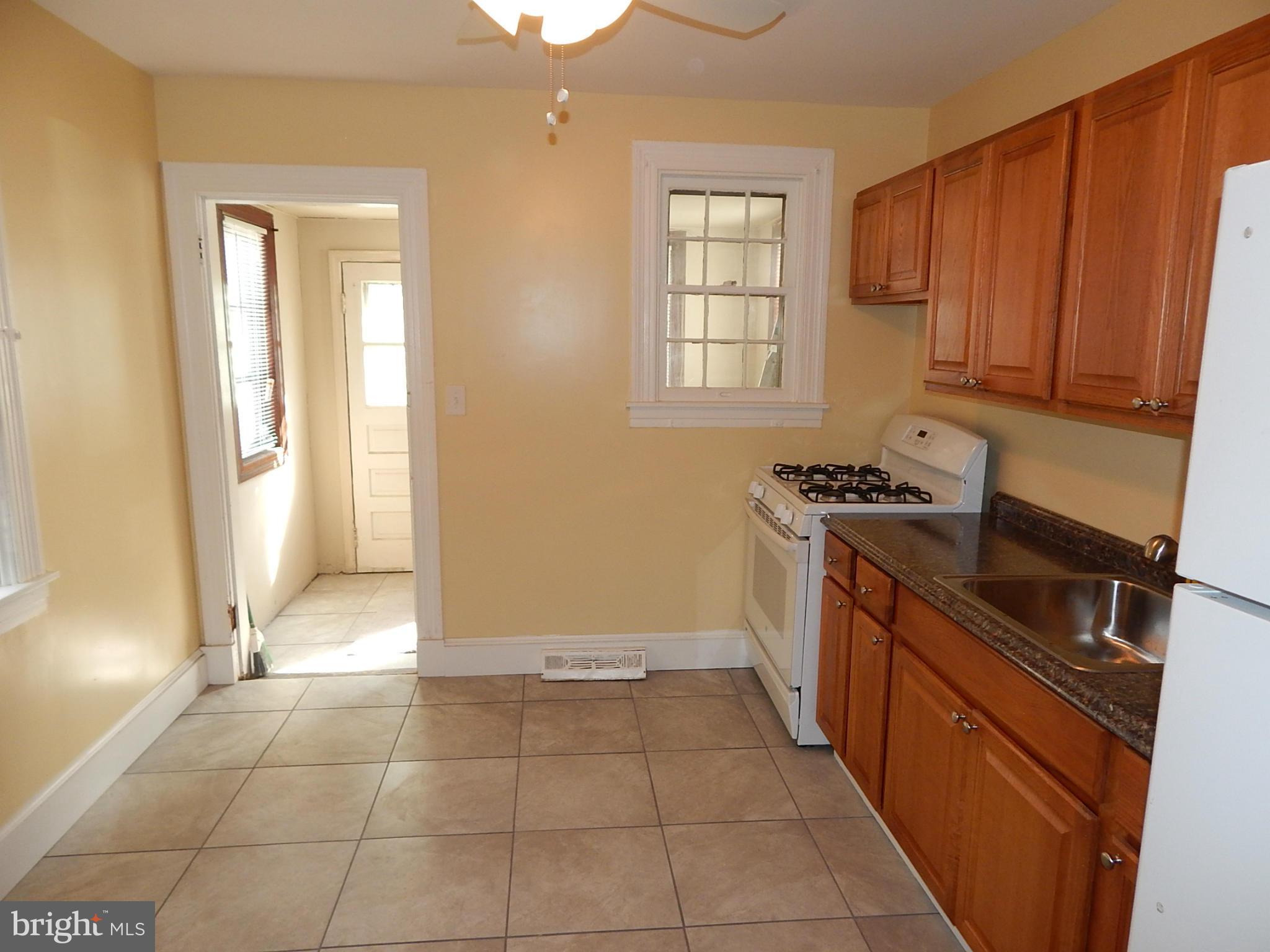 12 Crafton Road Baltimore, MD 21221 - Photo 6 of 28 a kitchen with a stove a sink and a cabinets