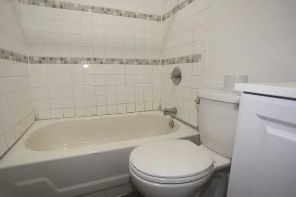 a white bath tub sitting next to a toilet